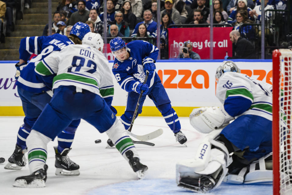 Toronto Maple Leafs right wing Mitchell Marner (16) shoots on Vancouver Canucks goaltender Thatcher Demko (35) during the second period of an NHL hockey match in Toronto on Saturday, Nov. 11, 2023. (Christopher Katsarov/The Canadian Press via AP)