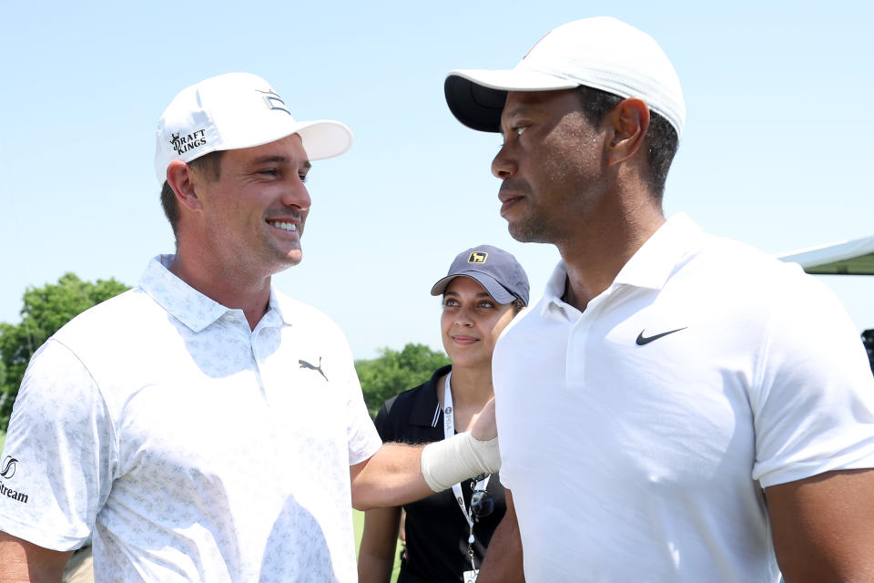 TULSA, OKLAHOMA - MAY 18: Bryson DeChambeau of the United States talks with Tiger Woods of the United States during a practice round prior to the start of the 2022 PGA Championship at Southern Hills Country Club on May 18, 2022 in Tulsa, Oklahoma. (Photo by Christian Petersen/Getty Images)