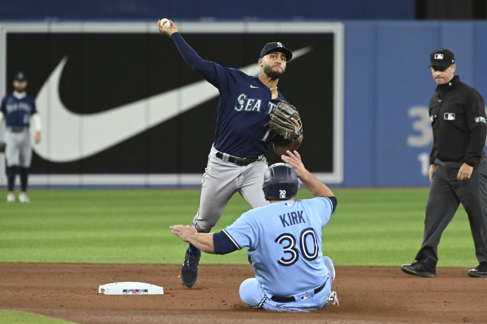 Toronto Blue Jays' Alejandro Kirk, 30, is forced out at second base by Seattle Mariners' Abraham Toro during the first inning of a baseball game in Toronto on Wednesday, May 18, 2022. (Jon Blacker/The Canadian Press via AP)