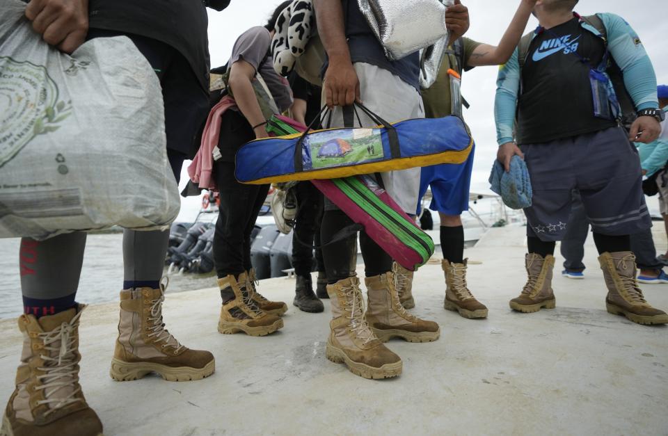 FILE - Venezuelan migrants arrive in Necocli, Colombia after they decided against crossing the Darien Gap and returned from Acandi, Oct. 13, 2022. Some Venezuelans reconsidered their journey after the U.S. announced on Oct. 12 that Venezuelans who walk or swim across the border will be immediately returned to Mexico without rights to seek asylum. (AP Photo/Fernando Vergara, File)