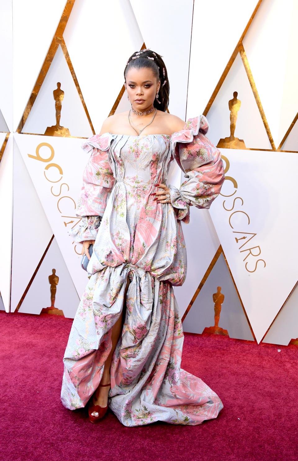 <p>Andra Day wears an off-the-shoulder multi-colour gown with long sleeves.</p>