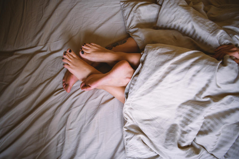 a couple with their feet together in bed