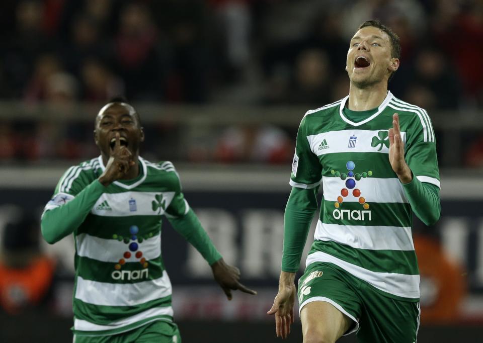 Panathinaikos' Marcus Berg of Sweden, right, celebrates after scoring the second goal of his team against Olympiakos during a Greek League soccer match at Georgios Karaiskakis stadium, in Piraeus port, near Athens, on Sunday, March 2, 2014. (AP Photo/Thanassis Stavrakis)