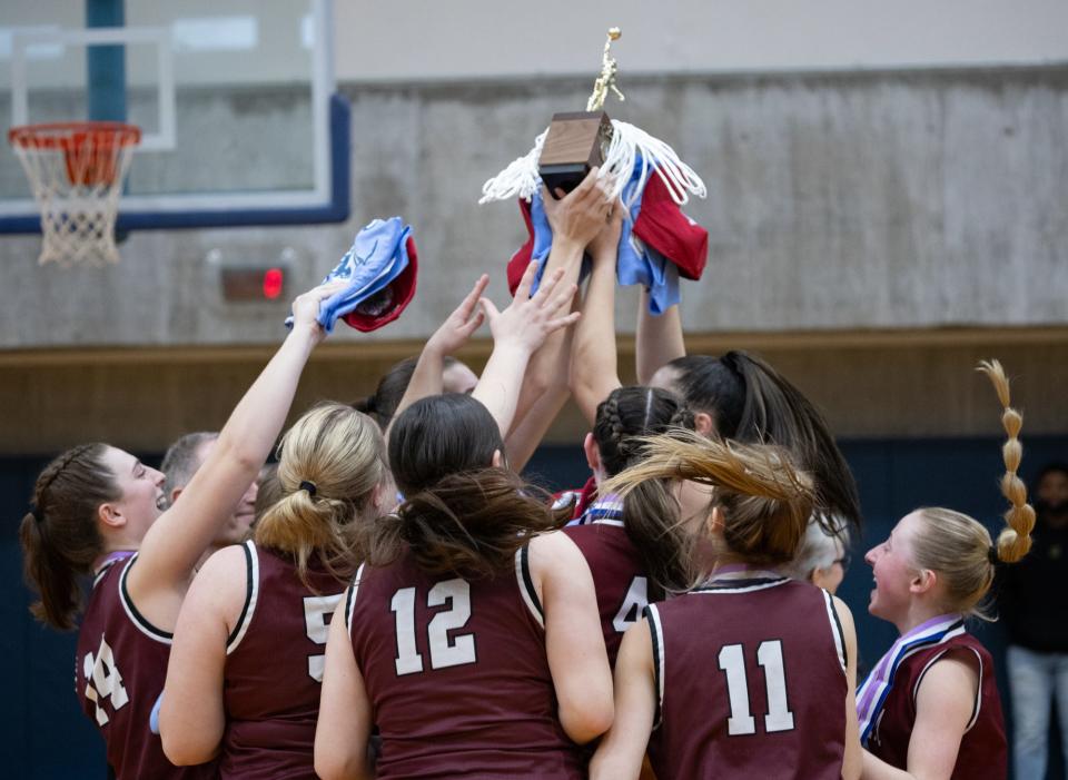 Elba players celebrate with the Section V Class D championship block after defeating CG Finney.