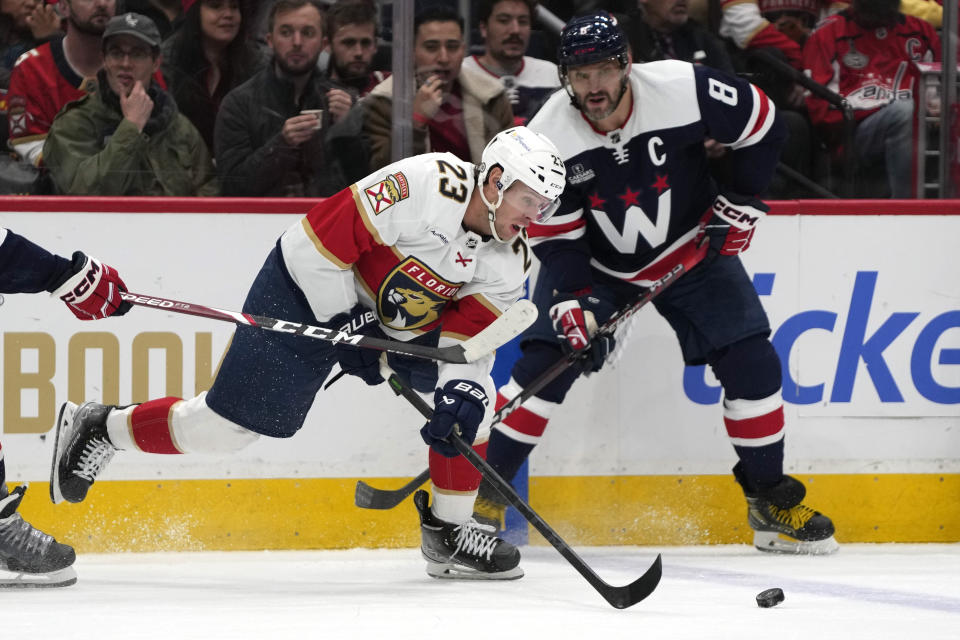 Florida Panthers center Carter Verhaeghe (23) skates with the puck past Washington Capitals left wing Alex Ovechkin (8) in the first period of an NHL hockey game, Wednesday, Nov. 8, 2023, in Washington. (AP Photo/Mark Schiefelbein)