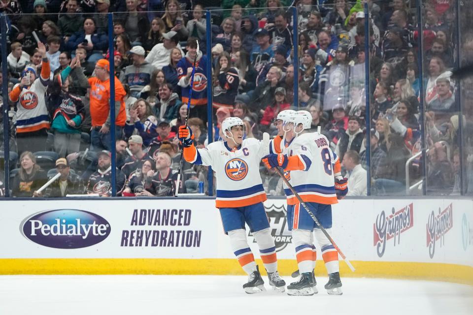 Mar 24, 2023; Columbus, Ohio, USA;  New York Islanders left wing Anders Lee (27) and defenseman Noah Dobson (8) celebrate a goal by center Brock Nelson (29) during the third period of the NHL hockey game against the New York Islanders at Nationwide Arena. The Blue Jackets won 5-4 in overtime. Mandatory Credit: Adam Cairns-The Columbus Dispatch