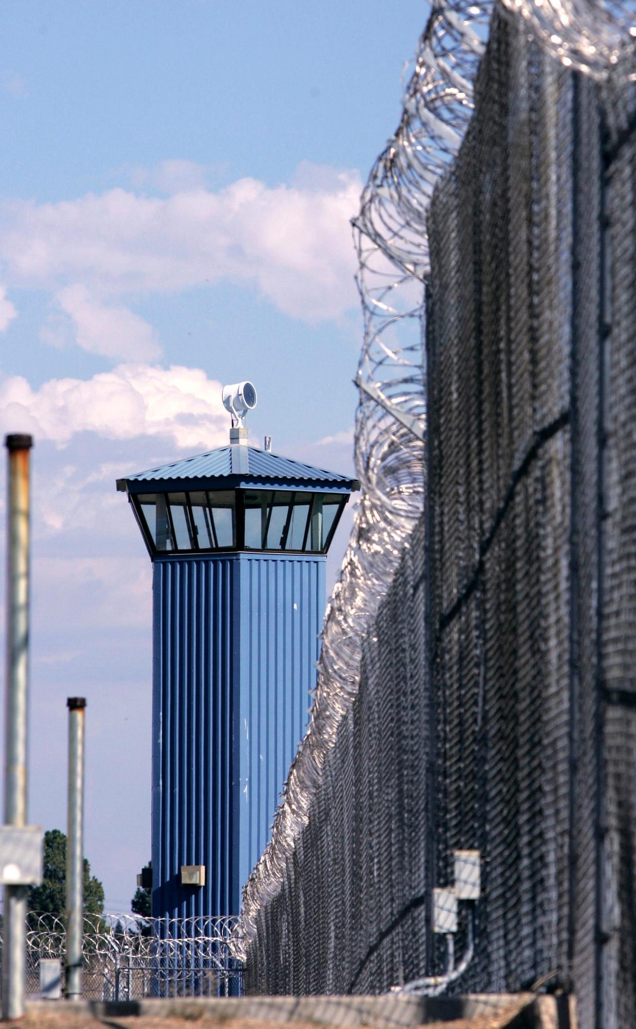 A guard tower is seen behind the wire fence that surrounds California State Prison, Sacramento, in Folsom.