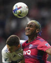 FC Dallas' Nkosi Tafari, right, gets his head on the ball while vying for it against Vancouver Whitecaps' Ranko Veselinovic during the second half of an MLS soccer match Wednesday, May 18, 2022, in Vancouver, British Columbia. (Darryl Dyck/The Canadian Press via AP)