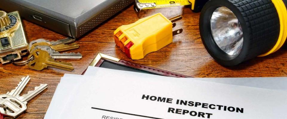 Real estate home inspection report of resale residential property condition with professional housing engineering inspector testing tools and house keys (fictitious but realistic document)