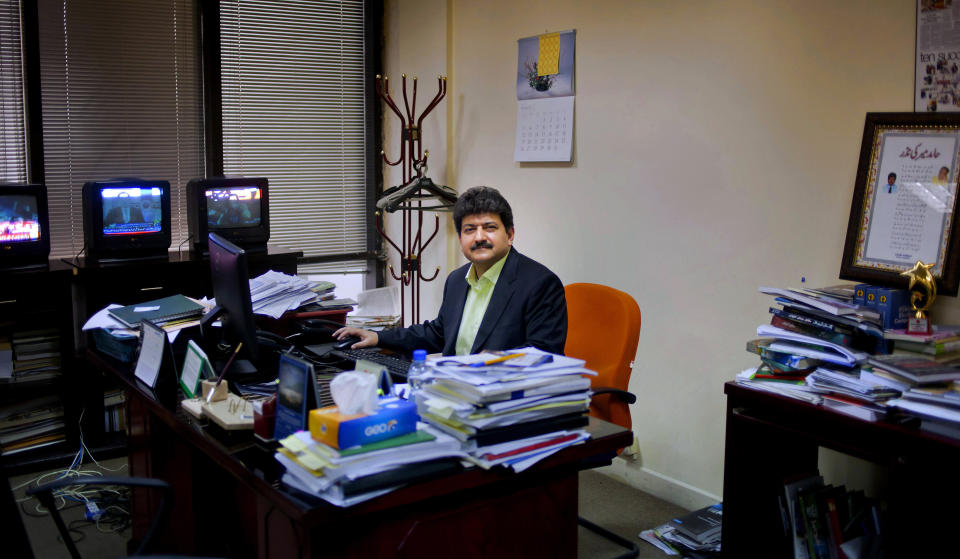 FILE - In this March 14, 2017, file, photo, Pakistani journalist Hamid Mir sits in his office in Islamabad, Pakistan. A Pakistani television station on Monday, May 31, 2021, took Mir off air, removing him as host of a popular talk show after he criticized the country’s powerful military. (AP Photo/Anjum Naveed, File)