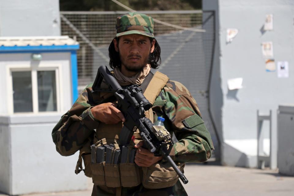 A Taliban soldier stands guard at the gate of Hamid Karzai International Airport in Kabul, Afghanistan, on Sept. 5, 2021. Some domestic flights have resumed at Kabul's airport, with the state-run Ariana Afghan Airlines operating flights to three provinces.