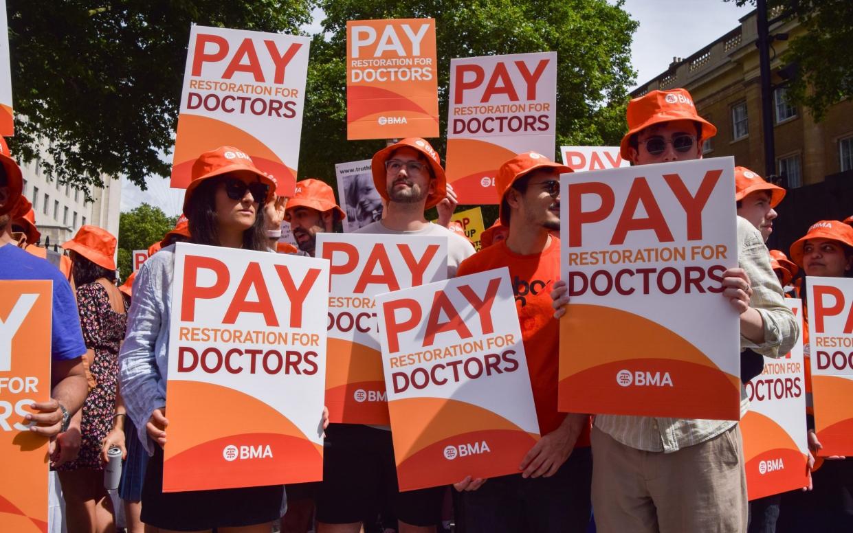 Junior doctors hold placards in support of fair pay during the demonstration