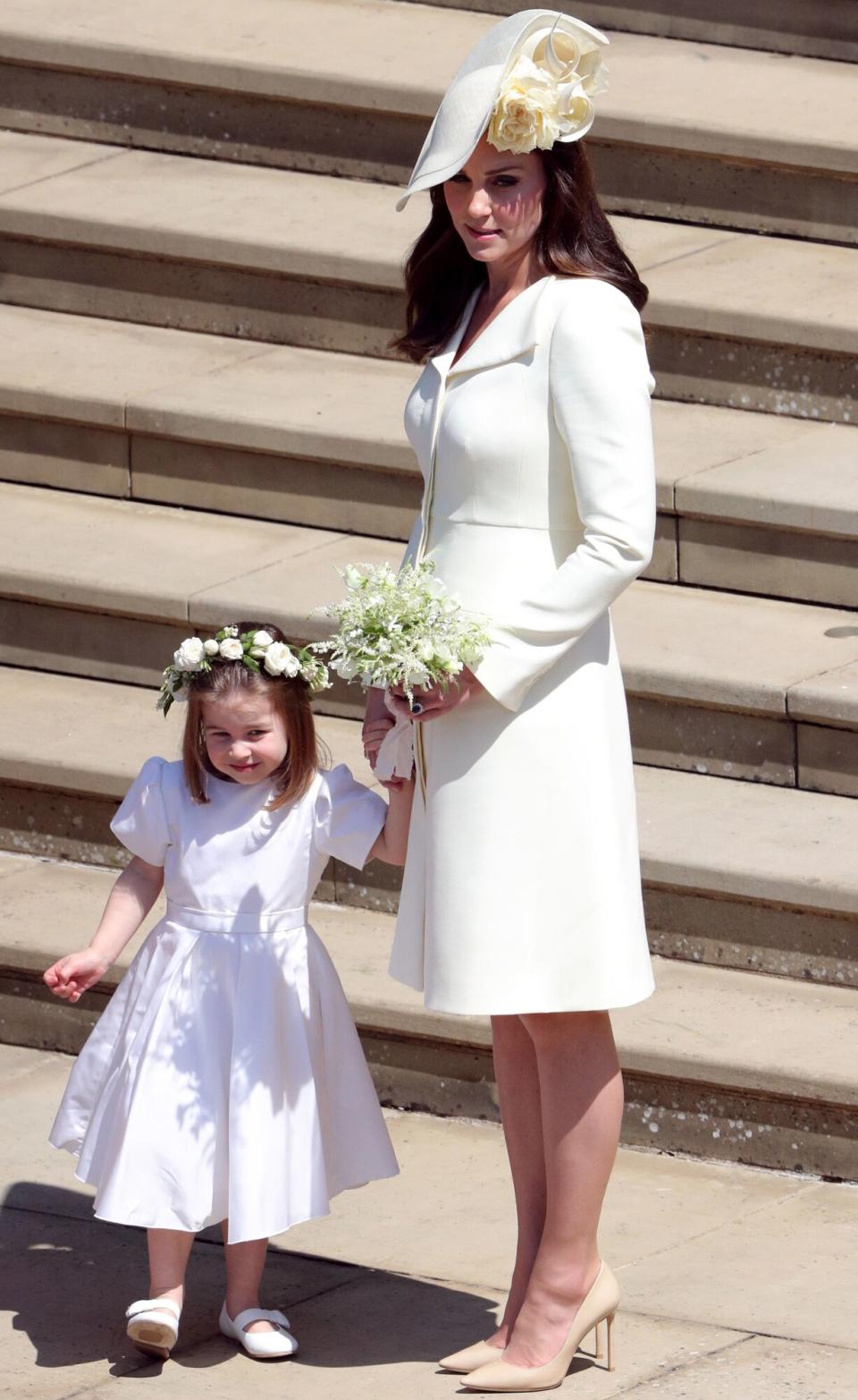 Catherine, Duchess of Cambridge and Princess Charlotte leave St George's Chapel, Windsor Castle after the wedding of Prince Harry, Duke of Sussex and Meghan, Duchess of Sussex on May 19, 2018 in Windsor, England