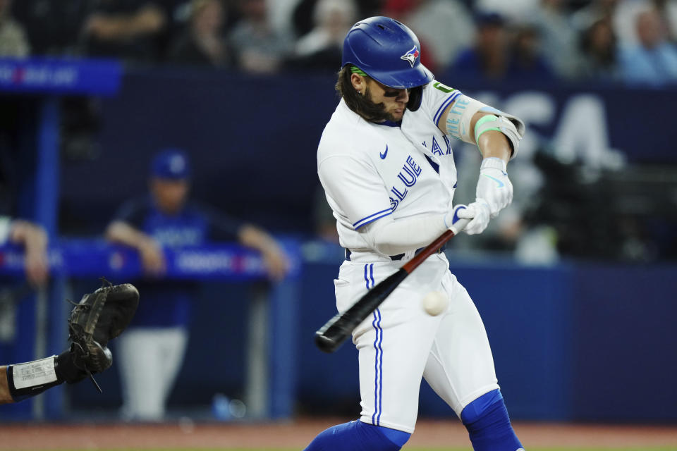 Toronto Blue Jays' Bo Bichette (11) hits an RBI double against the Kansas City Royals during the sixth inning of a baseball game Friday, Sept. 8, 2023, in Toronto. (Nathan Denette/The Canadian Press via AP)