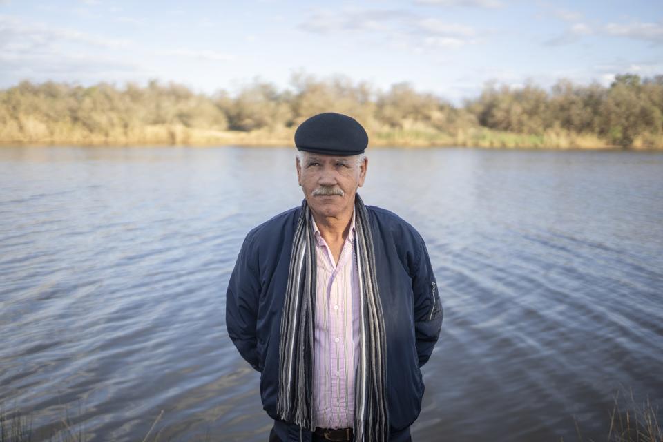 Mimoun Nadori poses for a portrait in front of the Moulouya River, in Nador, Morocco, Friday, March 8, 2024. Less rainfall and more damming and pumping upstream has left less water flowing through the river and threatened the livelihoods of farmers like Nadori. (AP Photo/Mosa'ab Elshamy)