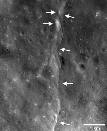 A prominent lunar thrust fault scarp, one of thousands of such cliffs on the moon’s landscape, discovered in Lunar Reconnaissance Orbiter Camera (LROC) images, (left-pointing white arrows) formed when the near-surface crust is pushed together, breaks and is thrust upward along a fault as the Moon contracts is shown in this photo taken August 15, 2018. NASA/GSFC/Arizona State University/Smithsonian/Handout via REUTERS