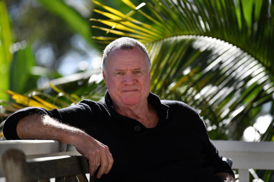 Aussie commentator and author Mike Carlton sitting on a bench.