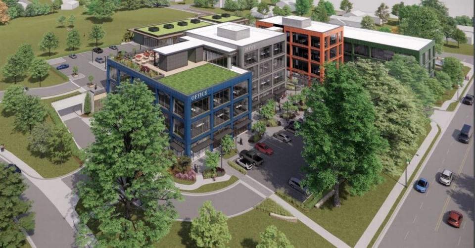 A previous rendering of a new office and retail development proposed for 50th Street and Rainbow Boulevard in Westwood shows four buildings with blue, gray, orange and green terra cotta exteriors. New design has replaced the colors with natural wood cladding.