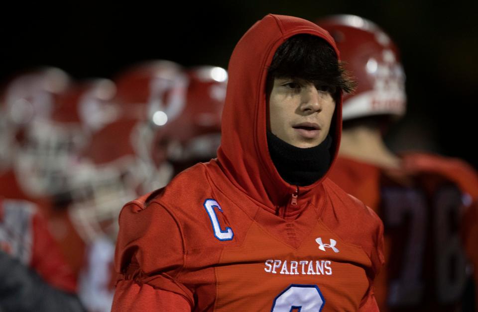 Ocean senior quarterback Tyler Douglas is shown standing on the sidelines during the Spartans' 34-7 defeat to Burlington Township Friday night in a NJSIAA South Group 3 quarterfinal. Douglas did not play due to a sprained AC joint in his left shoulder.