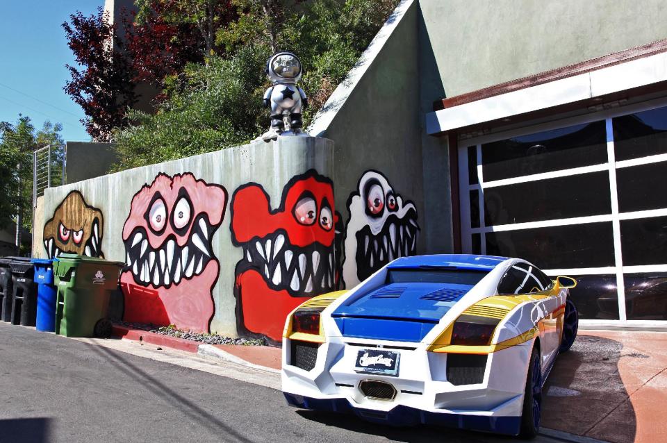 This Sunday May 12,2013 photo shows a mural painted on the outside of musician Chris Brown's home in Los Angeles. The Grammy-winning musician's neighbors are unhappy with what some are calling frightening art he's chosen to have painted along the curb of his Hollywood Hills home. (AP Photo/Richard Vogel)