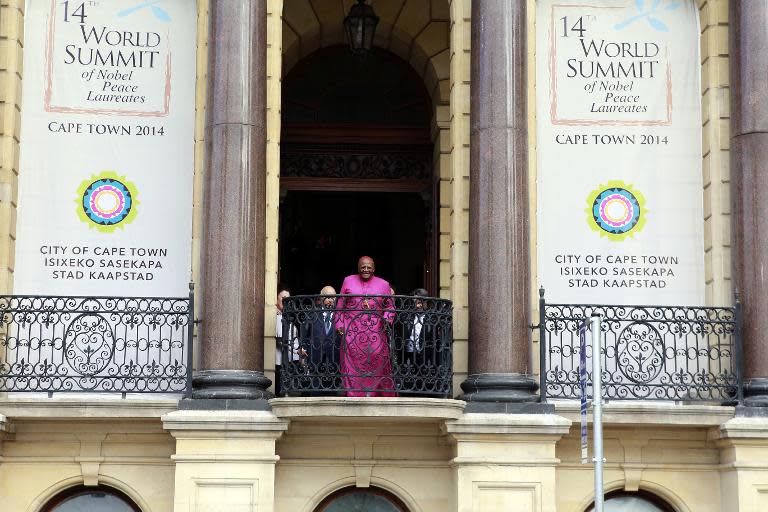 Archbishop Desmond Tutu stands on the balcony of the Cape Town City Hall during the unveiling of the official theme for the 14th World Summit of Nobel Peace Laureates, on July 18, 2014 in South Africa