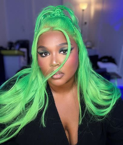 <p>Lizzo Instagram</p> Lizzo shares a selfie of her new neon-green hairstyle