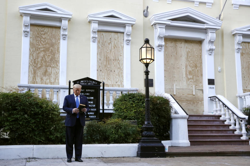 President Donald Trump holds a Bible as he visits outside St. John's Church across Lafayette Park from the White House Monday, June 1, 2020, in Washington. Part of the church was set on fire during protests on Sunday night. (AP Photo/Patrick Semansky)