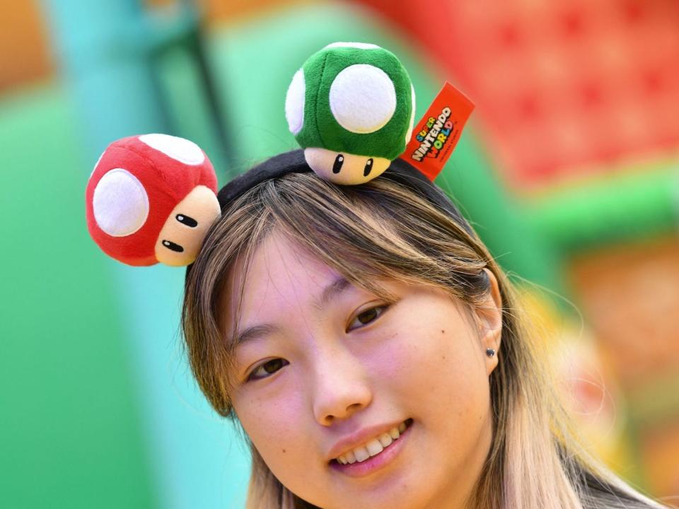 A guest wears a Nintendo headband during a preview of Super Nintendo World at Universal Studios in Los Angeles, California, on January 13, 2023.