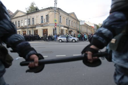 Law enforcement officers stand guard after a rally to demand authorities allow opposition candidates to run in a local election in Moscow