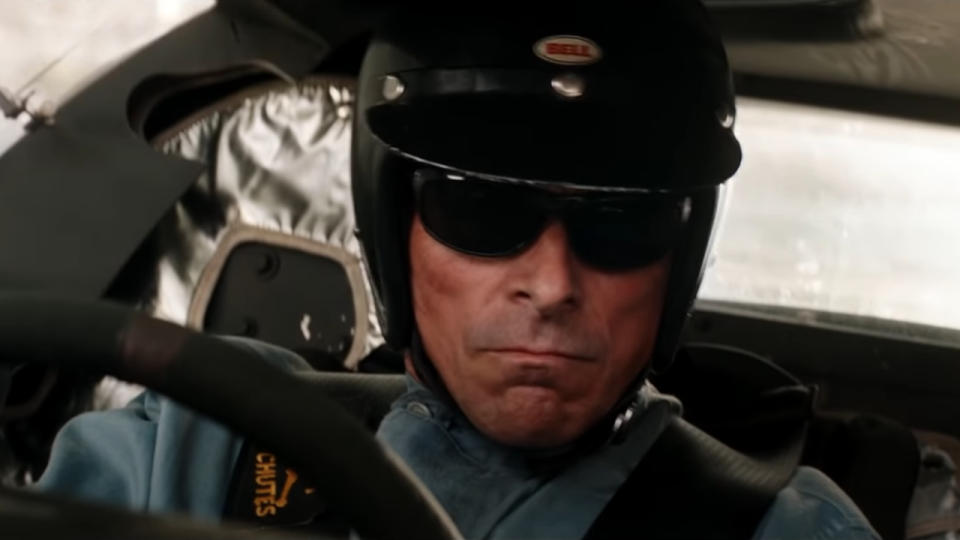 Christian Bale looking serious while driving a race car in Ford v. Ferrari.