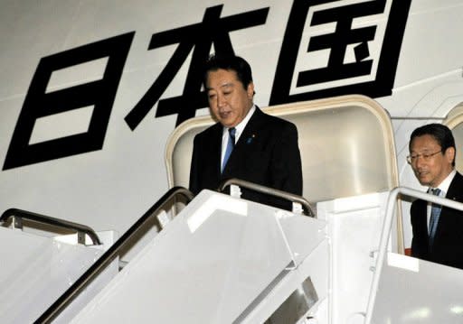 Japanese Prime Minister Yoshihiko Noda arrives at the Hickam Air Force Base in Honolulu, Hawaii, on November 11, to attend the Asia-Pacific Economic Cooperation (APEC) Summit. Noda on Saturday urged Russia to engage in more substantial talks on a long-running island dispute, saying that the two nations should be "calm" in their discussions