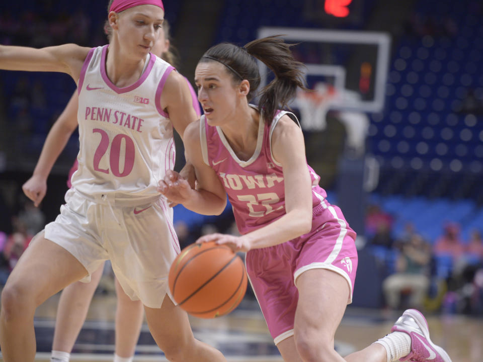 Iowa's Caitlin Clark (22) drives the baseline on Penn State's Makenna Marisa (20) during the second half of an NCAA college basketball game, Sunday, Feb. 5, 2023, in State College, Pa. (AP Photo/Gary M. Baranec)