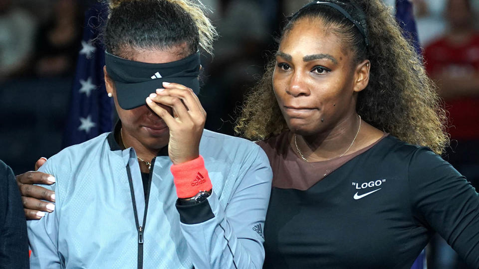 Naomi Osaka weeps beside Serena Williams during the presentation. (Photo by TIMOTHY A. CLARY / AFP / Getty Images)