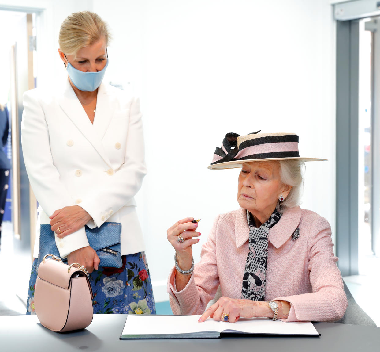 BRISTOL, UNITED KINGDOM - JULY 07: (EMBARGOED FOR PUBLICATION IN UK NEWSPAPERS UNTIL 24 HOURS AFTER CREATE DATE AND TIME) Sophie, Countess of Wessex looks on as Princess Alexandra signs the visitor's book during a visit to the Guide Dogs for the Blind Association to open their new south west regional centre and celebrate the charity's 90th anniversary on July 7, 2021 in Bristol, England. During the visit Princess Alexandra, who has been patron the Guide Dogs for the Blind Association since 1954, formally handed over the patronage to Sophie, Countess of Wessex. (Photo by Max Mumby/Indigo/Getty Images)