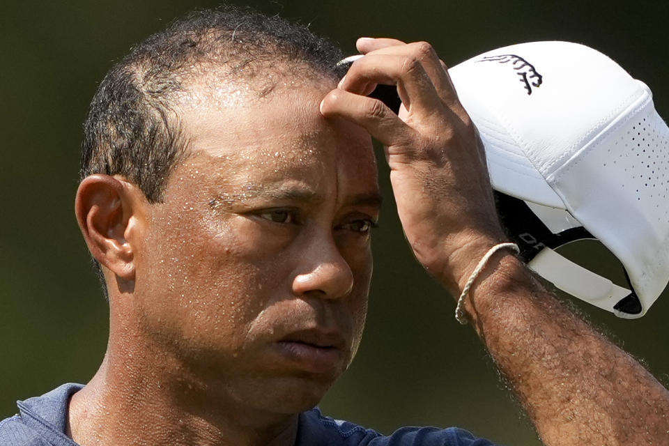 Tiger Woods wipes his face on the 10th hole during hot weather warnings in second round of the U.S. Open golf tournament Friday, June 14, 2024, in Pinehurst, N.C. (AP Photo/Matt York)