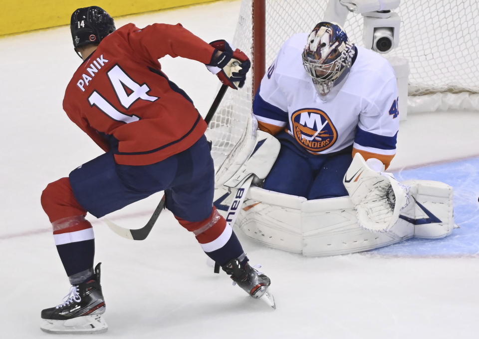 New York Islanders goaltender Semyon Varlamov (40) makes save on Washington Capitals right wing Richard Panik (14) during the first period of an NHL Stanley Cup playoff hockey game in Toronto on Thursday, Aug. 20, 2020. (Nathan Denette/The Canadian Press via AP)
