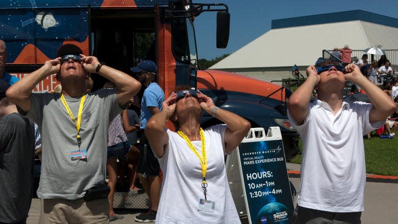 The right way to do it: Visitors at Kennedy Space Center watch the eclipse through eclipse glasses on August 21, 2017. - Photo: NASA