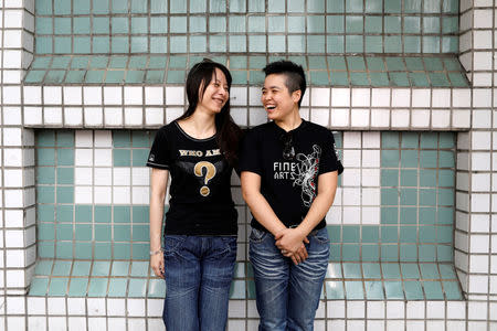 Wang Yi (R), 32, an artist and Meng Yu-mei, 34, a sales assistant, pose for a photograph in New Taipei City, Taiwan, May 14, 2017. REUTERS/Tyrone Siu