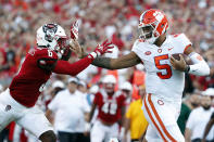 Clemson's D.J. Uiagalelei (5) stiff arms North Carolina State's Jakeen Harris (6) during the second half of an NCAA college football game in Raleigh, N.C., Saturday, Sept. 25, 2021. (AP Photo/Karl B DeBlaker)