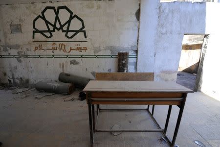 The logo of Jaish al-Islam is seen at a damaged school in al-Kalasa district of Aleppo July 12, 2017. REUTERS/ Omar Sanadiki