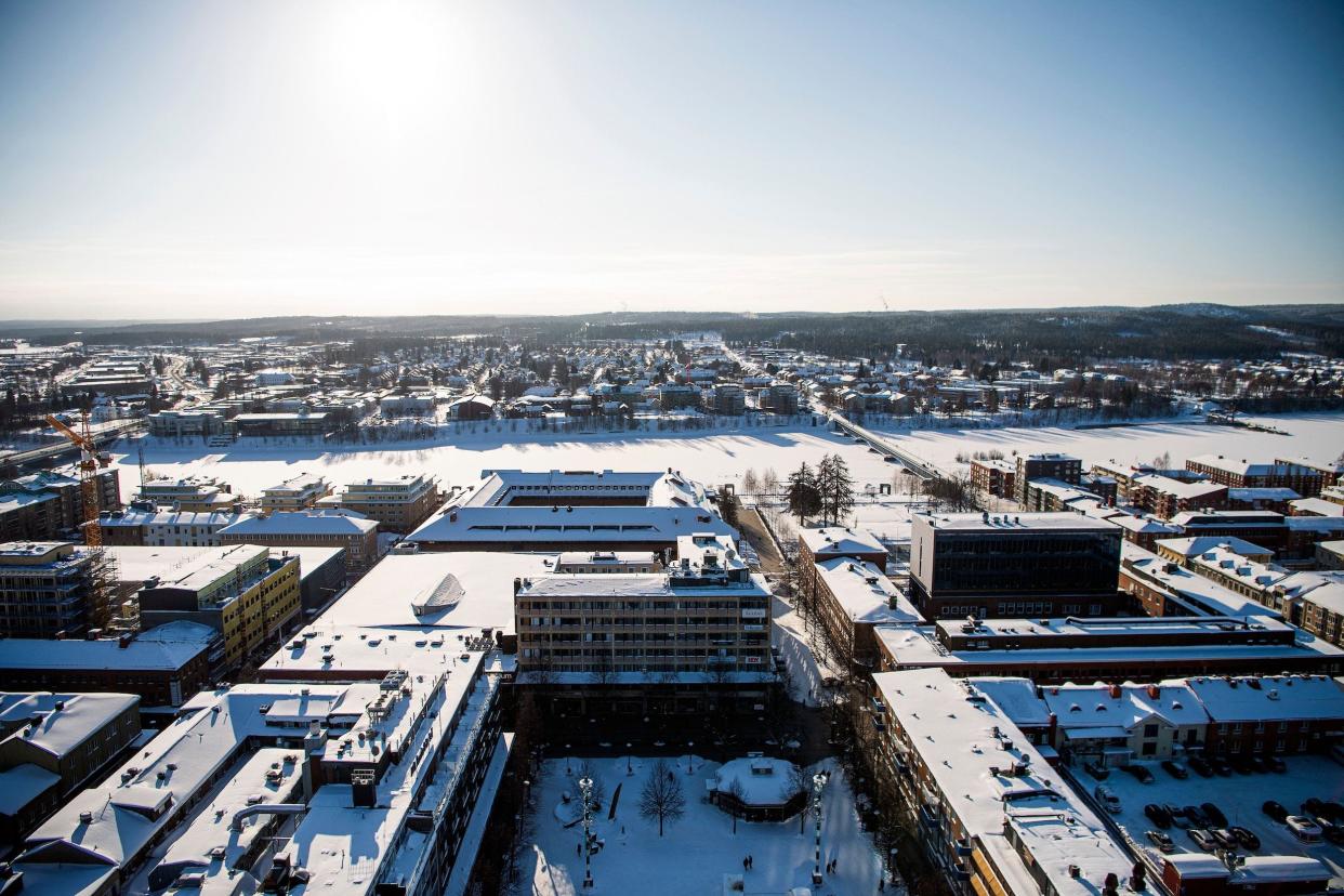 Miles of buildings covered in snow viewed from a high vantage point