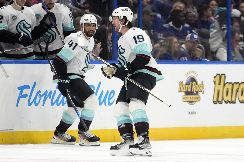 Seattle Kraken left wing Jared McCann (19) celebrates his overtime goal against the Tampa Bay Lightning with left wing Pierre-Edouard Bellemare (41) an NHL hockey game Monday, Oct. 30, 2023, in Tampa, Fla. (AP Photo/Chris O'Meara)