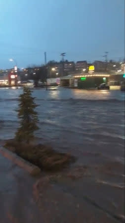 Floodwaters flow along a street in Pullman, Washington, U.S. in this still image taken from April 9, 2019 social media video. ELLIE STENBERG/via REUTERS