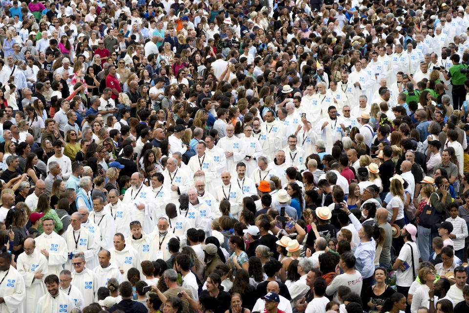 Priests walk through the crowd as they arrive at the "Velodrome Stadium", in Marseille, France, where Pope Francis will celebrate mass, Saturday, Sept. 23, 2023. Francis, during a two-day visit, will join Catholic bishops from the Mediterranean region on discussions that will largely focus on migration. (AP Photo/Alessandra Tarantino)