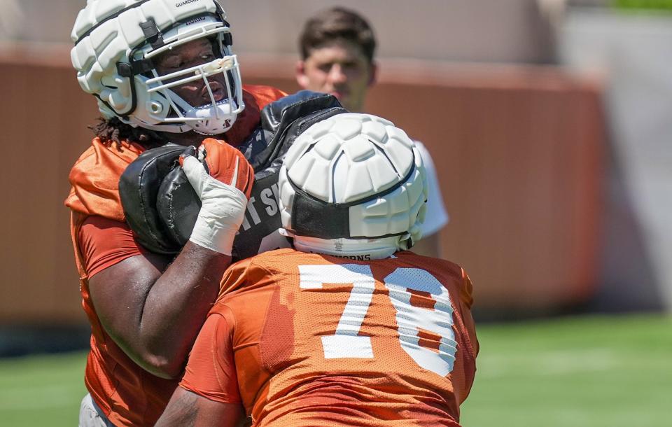 Texas offensive lineman Neto Umeozulu, left, battles teammate Kelvin Banks Jr. in a practice drill last season. Umeozulu has impressed coaches and teammates this spring while trying to earn the starting nod at left guard.