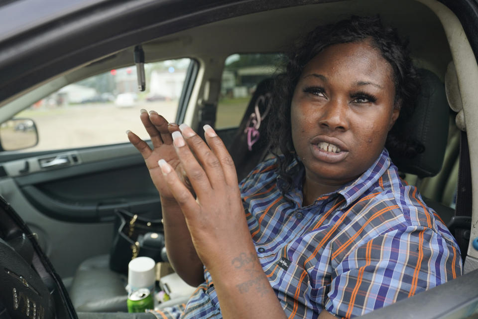 Carey Wooten speaks of her appreciation for the drive-thru water distribution in Jackson, Miss., but expresses disappointment of the city's progress with dealing with the longstanding water issues, on Sept. 7, 2022. As a mother of two adolescent boys, she noted how quickly two cases of water are used by her family. (AP Photo/Rogelio V. Solis)