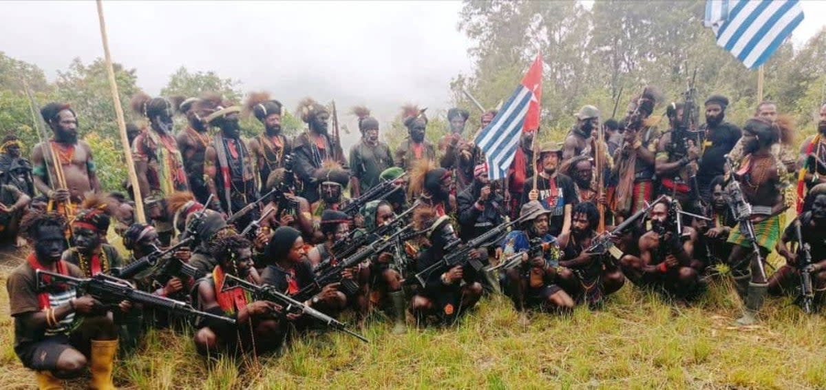 Still from the video released by TPNPB shows New Zealand pilot Philip Mehrtens sitting among separatist fighters and holding their flag in Indonesia’s Papua region in this undated handout picture released on 26 May (The West Papua National Liberation Army (TPNPB)/Handout via REUTERS)