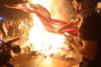 Un grupo de manifestantes queman una bandera de Estados Unidos durante una manifestación en Washington el 31 de mayo. (Foto: Jonathan Ernst / Reuters).