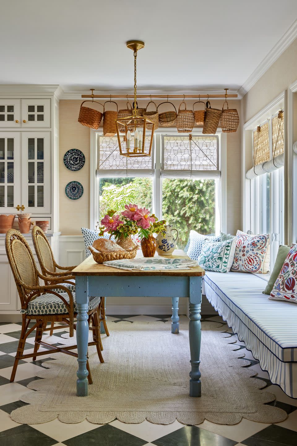 breakfast nook in kitchen of country home with baskets hanging from the ceiling