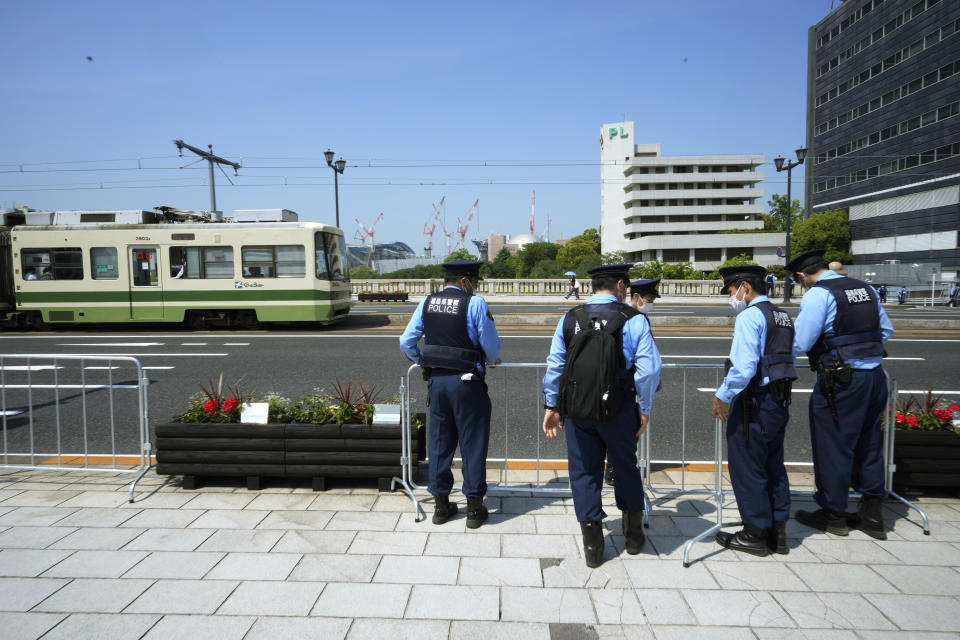 Police officers set up barricades along a street as Japan's police beef up security ahead of the Group of Seven nations' meetings in Hiroshima, western Japan, Wednesday, May 17, 2023. The G-7 summit starts Friday. (AP Photo/Hiro Komae)
